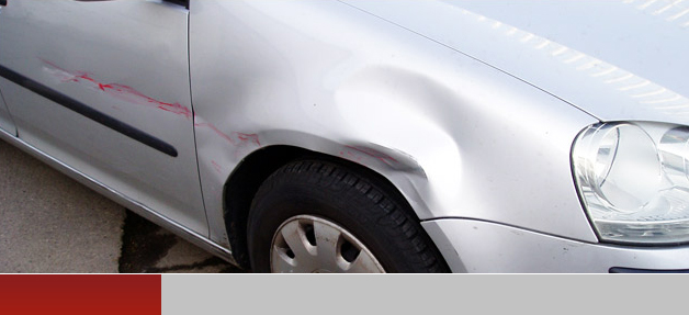 Silver car with dents in bodywork